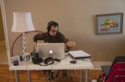 Physical theater artist Matt Chapman of Blue Lake, Calif., a two-and-a-half-week artist in residence, rehearses music inside the Pilot Balloon Church-House.