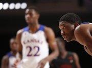 Kansas center Joel Embiid looks across the lane as Andrew Wiggins lines up for a pair of free throws during the second half on Saturday, Nov. 30, 2013 in Paradise Island, Bahamas.