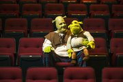 Knute Pittenger, in costume as Shrek, the title character in Theatre Lawrence’s upcoming production, sits in the Theatre Lawrence seats with a stuffed Shrek toy Tuesday. Pittenger has been the lead actor in several Theatre Lawrence musical productions, a far cry from his day job as an employee for the city’s Water Department. “Shrek” opens Friday at Theatre Lawrence, 4660 Bauer Farm Drive, and runs through Dec. 22.