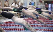 Free State swimmer Jack Ziegler dives off of the block during the final head of the Boys 50 Yard Freestyle event on Wednesday, Dec. 4, 2013 during a quad at Free State High School.
