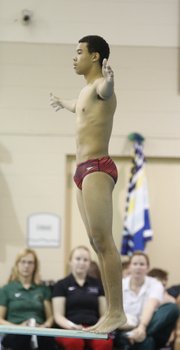 Lawrence High's Izaiah Bowie prepares himself for a dive on Wednesday, Dec. 4, 2013 during a quad at Free State High School.