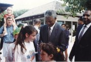 Whitney Kleinmann, seated on her father's shoulders at left, remembers her family meeting Nelson Mandela by chance during a cruise to the Bahamas in 1994, when she was 4. Kleinmann, who now lives in the Kansas City area, graduated from Kansas University in May.