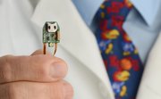Kansas University School of Medicine professor and neurobiologist Randalph Nudo holds a tiny device that helped restore motor skills in brain-damaged mice. Photo courtesy of KU.