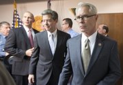 U.S. Attorney Barry Grissom, right, followed by Kansas Gov. Sam Brownback, leaves a news conference after announcing the arrest of Terry Lee Loewen, 58, of Wichita, Kan., on Friday, Dec. 13, 2013, in Witchita, Kan. Grissom said Loewen was arrested Friday morning at Mid-Continent regional airport where he planned to drive a car that he believed was full of explosives into a terminal at the airport. (AP Photo/The Wichita Eagle, Travis Heying)