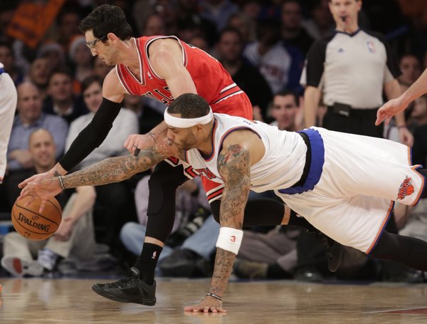 New York Knicks forward Kenyon Martin (3) dives for the ball as Chicago Bulls guard Kirk Hinrich (12) dribbles in the first half of their NBA basketball game at Madison Square Garden in New York, Wednesday, Dec. 11, 2013. (AP Photo/Kathy Willens)