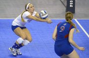 Kansas University libero Brianne Riley, left, digs the ball as Caroline Jarmoc stands by during an NCAA Tournament regional semifinal match against Washington on Friday, Dec. 13, 2013, in Los Angeles