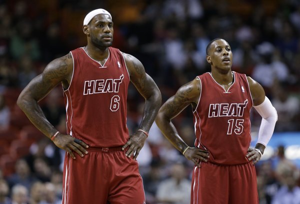 Miami Heat's LeBron James (6) and Mario Chalmers (15) stand on the court during the first half of an NBA basketball game against the Detroit Pistons, Tuesday, Dec. 3, 2013, in Miami. (AP Photo/Lynne Sladky)