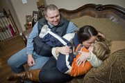 Jason and Jennifer Thornton and their 5-year-old son Hayden share a family moment on the couch at home in Leavenworth. Jason, retired medically from the Army, suffers from PTSD and chronic depression. Jennifer is getting her masters in social work at KU.