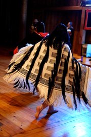 Grace Denning, a Haskell student and member of the Tlingit tribe of Alaska, wears a raven's tail robe during a traditional dance performance. The traditional Tlingit robe was hand-twined, without the use of a loom, by artist Teri Rofkar.