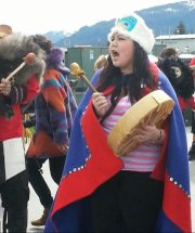Grace Denning leads songs during a parade in Wrangell, Alaska. Denning, a Haskell Indian Nations University Student from Alaska, is a member of the Tlingit tribe.
