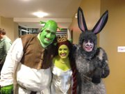 Jake Leet, right, in his Donkey costume with cast mates before a performance of "Shrek" at Theatre Lawrence.