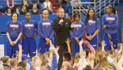 Kansas University coach Bonnie Henrickson, center, and the KU women’s basketball team greet young fans during a holiday hoops clinic, Friday, Dec. 27, 2013, at Allen Fieldhouse.
