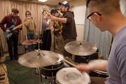 From left, Ben Kimbal, Sam Mitchie, Claire Vowels, Maxfield Yoder, Danny Barkofske, and Nicholas Stahl of the band Dean Monkey and the Dropouts practice at the SeedCo Studios as part of Whatever Music Collective.