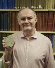 Paul Selden, the Gulf-Hedberg Distinguished Professor at Kansas University and director of the KU Paleontological Institute, holds a Jurassic-era spider that was about the size of a human hand. Photo courtesy of Paul Selden and KU.