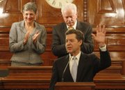 Gov. Sam Brownback delivers his annual State of the State address in the House of Representatives at the Statehouse in Topeka, Wednesday, Jan. 15, 2014. Brownback's speech outlined his policy priorities for the 2014 legislative session. Behind Brownback are Senate president Susan Wagle and Speaker of the House Ray Merrick.