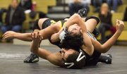 Free State sophomore Quailan Fowler, bottom wraps up Topeka High's JP Gallegos during their 113# wresting match, Thursday evening at FSHS.