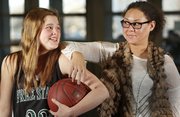 Free State freshman Madison Piper, left, and assistant coach Taylor Manning try to make each other laugh during a portrait shoot on Thursday, Jan. 23, 2014 at Free State High. Both hail from basketball families with their fathers, Chris Piper and Danny Manning, having played together for the Jayhawks in the late 80s and notably on the 1988 national championship team.