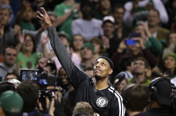 Brooklyn Nets forward Paul Pierce, center, formerly of the Boston Celtics, waves to the crowd during a tribute to him in an NBA basketball game against the Boston Celtics, Sunday, Jan. 26, 2014, in Boston. (AP Photo/Steven Senne) 