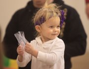 Violet Russell, holds a 'snowflake' as she dances around a class taught by Sarah Niileksela, a practicing music therapist, who teaches a class at Jump for Joy 1035 E 23rd St. in Lawrence.