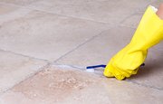 For small grout stains between tiles, try erasing the stain with a standard pencil eraser or use toothpaste and a toothbrush to scrub the area clean.