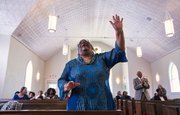 Sister Gloria Evans gives praise during a worship service at St. Luke AME church, 900 New York St. on Sunday, Feb. 16, 2014.