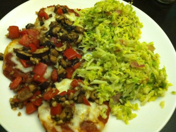 Polenta, topped with pizza implements, and served alongside sauteed Brussels sprouts.