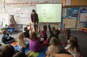 Kennedy Elementary School full-day kindergarten teacher Lauren Mitchell uses an interactive whiteboard to teach her students about rhyming and poetry. Mitchell said the technology helps create an engaging environment needed to hold young children's attention all day.