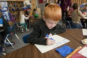 Kindergartner Carter Harris works on sounding out words in Lauren Mitchell's class at Kennedy Elementary School.