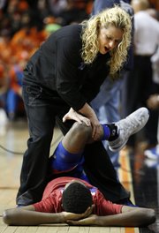 Kansas University men's basketball strength coach Andrea Hudy stretches out Andrew Wiggins, who is most likely to declare his intention to enter the NBA Draft after his freshman season.