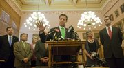 In press conference Friday, Kansas Governor Sam Brownback, flanked by legislators and staff including at right, Senator Susan Wagle, President of the Senate and Attorney General Derek Schmidt discusses the Kansas Supreme Court's ruling on the Gannon vs. State of Kansas.