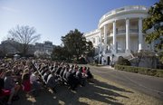 President Barack Obama, far right, welcomes members of 2012-2013 NCAA Division I Men’s and Women’s championship teams from several sports on the South Lawn of the White House in Washington, Monday, March 10, 2014.