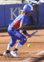 Kansas University senior Ashley Newman puts down a bunt in the Jayhawks' softball meeting with Northern Illinois on Friday, March 14, 2014, at Arrocha Ballpark.