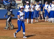 Kansas senior Alex Jones points toward first base at teammate Maddie Stein after a single by Stein drove Jones home for a run during their game against Jackson State, Saturday at Arrocha Ballpark.