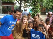 Madeline Heeren and Aqmar Rahman, law students at Kansas University, give a T-shirt to a child in a slum on the outskirts of Dhaka, Bangladesh last summer. After their trip to Bangladesh, Heeren and Rahman co-founded United Across Borders, a nonprofit organization that aims to provide clothing and blankets to the impoverished in developing countries.