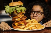 Richard Gwin/Journal World Photo.Journal World reporter Nadia Imafidon looks to take on the challenge of eating the "Everest Challenge", at the 23rd Street Brewery.