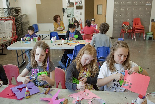Mike Yoder/Journal-World Photo.From left Lindsey Smith, Vivian Moriarty and Willoughby Lam, create decorations for downtown parking meters, during their Guerilla Art spring break camp at the Lawrence Arts Center, Wednesday, March 19, 2014. The week long camp including making art pieces that could be performed or attached in public places with the purpose of affecting the world in a creative way.