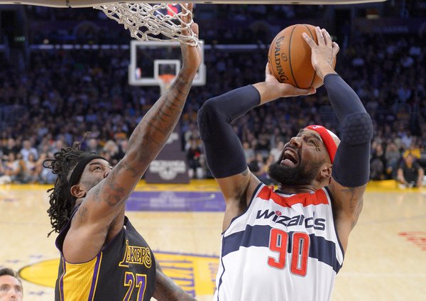 Washington Wizards forward Drew Gooden puts up a shot as Los Angeles Lakers forward Jordan Hill defends during the first half of an NBA basketball game, Friday, March 21, 2014, in Los Angeles. (AP Photo/Mark J. Terrill)