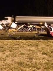 The semi-trailer truck was hauling garden hoses. Hundreds are strewn among debris for 100 yards around two westbound lanes of the toll plaza at mile marker 217 as drivers pass.