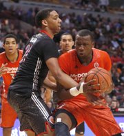 McDonald’s West All-American Jahlil Okafor, left, fouls McDonald’s East All-American Cliff Alexander during the second half of the West’s 105-102 victory Wednesday in Chicago.