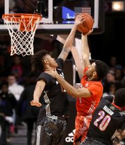 McDonald’s West All-American Kelly Oubre, left, blocks the shot of McDonald’s East All-American James Blackmon Jr. during the first half of the McDonald’s All-American Game on Wednesday in Chicago. Oubre is a Kansas University signee. Blackmon is headed to Indiana.