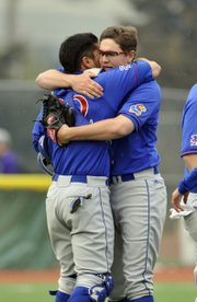Kansas University pitcher Frank Duncan, right, gets a hug from catcher Ka’iana Eldredge after striking out the final batter in Duncan’s complete-game victory on Sunday, April 6, 2014, in Manhattan.