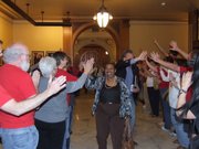Democratic Sens. Oletha Faust-Goudeaux of Wichita and Tom Holland of Baldwin City receive walk through a phalanx of teachers who were grateful for their votes against a school finance bill that would also repeal their tenure rights. The bill passed both chambers anyway and is now on its way to Gov. Sam Brownback for his signature.