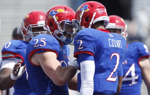 Blue Team running back Brandon Bourbon (25) celebrates with quarterback Montell Cozart after a touchdown by Cozart against the White Team during the second half of the Kansas Spring Game on Saturday, April 12, 2014 at Memorial Stadium. Nick Krug/Journal-World Photo