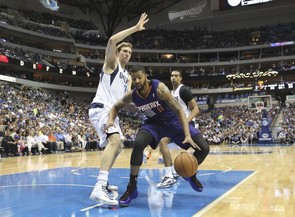 Dallas Mavericks guard Monta Ellis (11) drives to the basket between Phoenix Suns forwards Markieff Morris (11) and Channing Frye (8) during the second half of an NBA basketball game on Saturday, April 12, 2014, in Dallas. The Mavericks won 101-98. (AP Photo/LM Otero)
