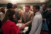 Kansas University men's basketball coach Bill Self signs a basketball for a fan after the Jayhawks' postseason awards banquet, Tuesday, April 15, 2014, at the Lawrence Holiday Inn.