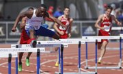 Kansas hurdler Michael Stigler glances over at the crowd as he clears a hurdle during the Mens 400 Meter Hurdles event of the Kansas Relays on Saturday, April 19, 2014 at Rock Chalk Park. Nick Krug/Journal-World Photo