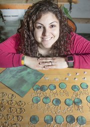 Britta McKee, a Kansas University graduate, is one of a handful of artists who are creating jewelry from old pieces of the Kansas Statehouse dome. McKee takes larger sections of the copper and cuts out small pieces to shape into rings, earrings and other jewelry.