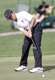 Lawrence High golfer Braxton Olson putts Wednesday at Eagle Bend during the Free State High School Invite golf tournament.