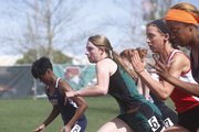 Free State junior Laura Kennard stretches out in the 100-yard prelims on Friday, April 25, 2014, at Free State.