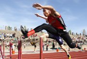 Lawrence High's Zach Sanders clears a hurdle in the 100 yard high hurdles on Friday, April 25, 2014, at Free State.